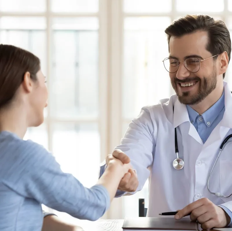 A doctor shaking a patients hand
