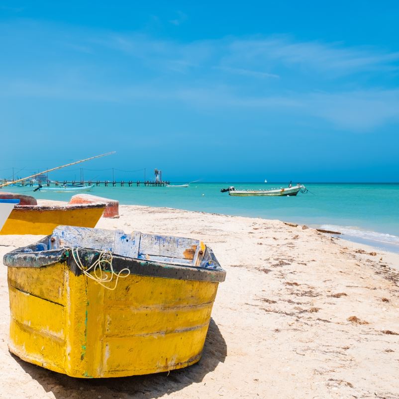 Small boats on a beach in Holbox island
