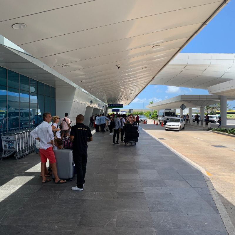 Taxis outside of Cancun International airport with travelers 