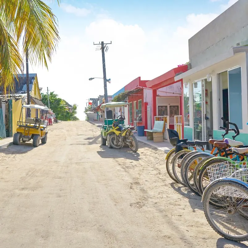 A road in Holbox with golf carts and bicycles