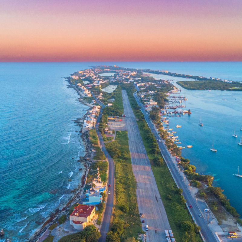 Aerial view of a strip with lots of hotels in Isla Mujeres