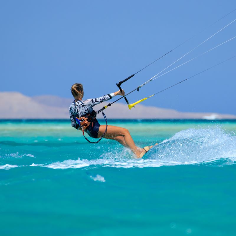 woman kitesurfing in ocean