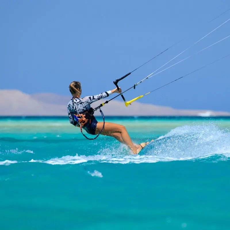 woman kitesurfing in ocean