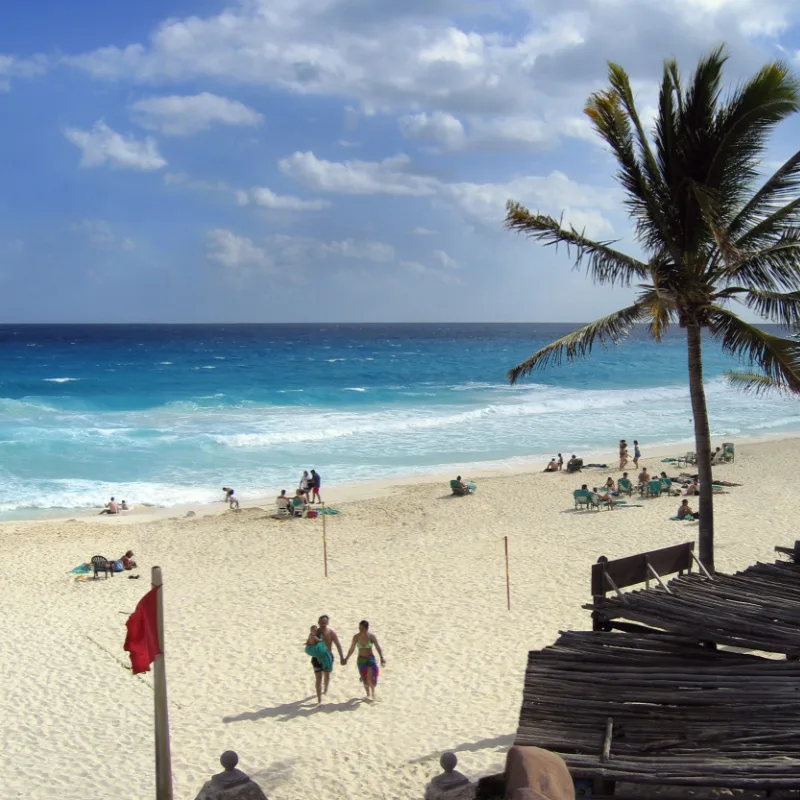 Family on a Beach in Cancun That Has a Red Flag Warning