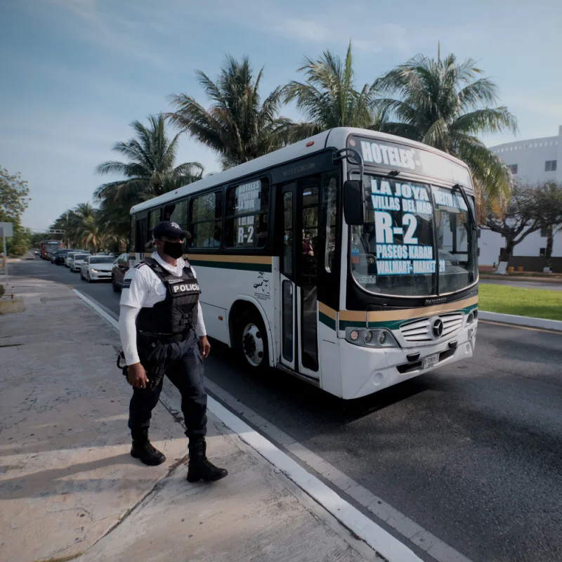 Police Officer Walking Down a Street in Cancun, Mexico