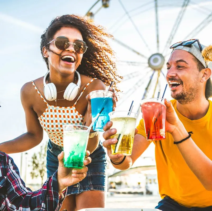 People toasting drinks together on a sunny day