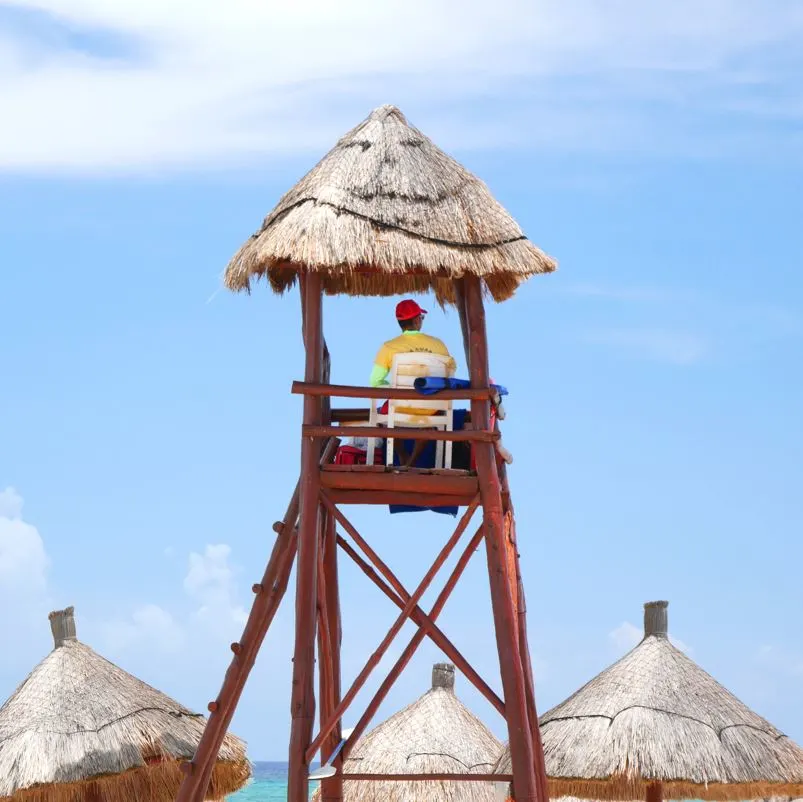 lifeguard watches beach in tulum