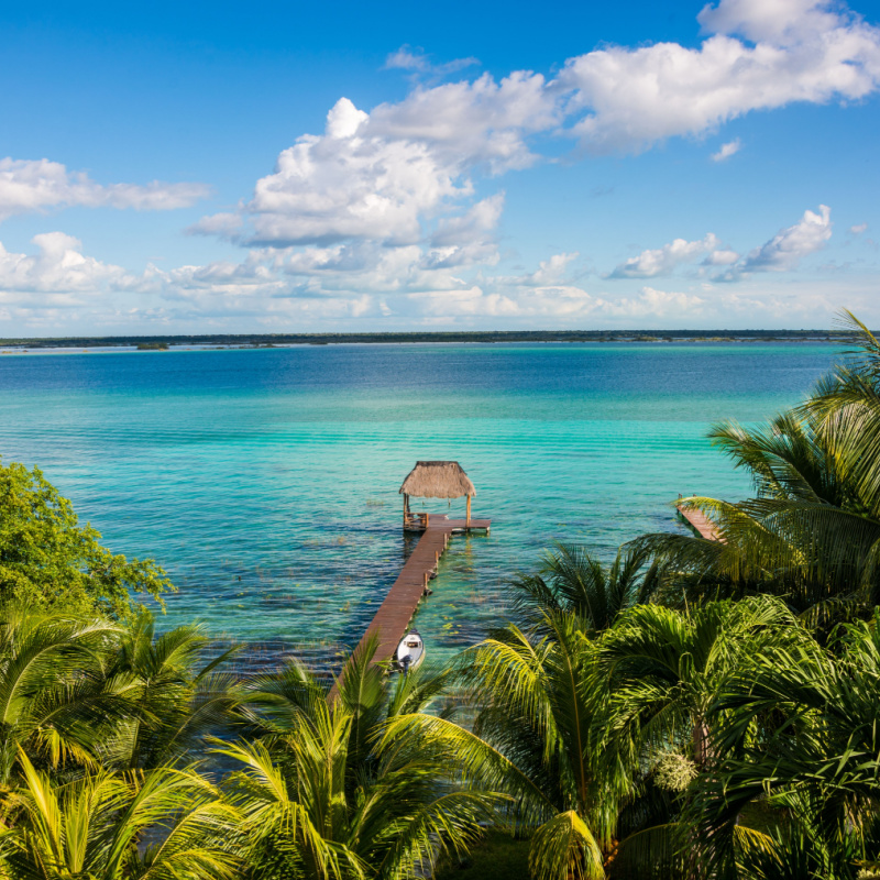 View of a lagoon in Bacalar with blue water and a hut