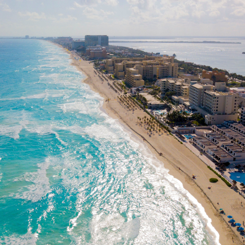 A stretch of all inclusive resorts in Cancun with beach
