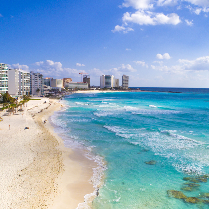 Aerial view of a beach in Cancun with high-rises 