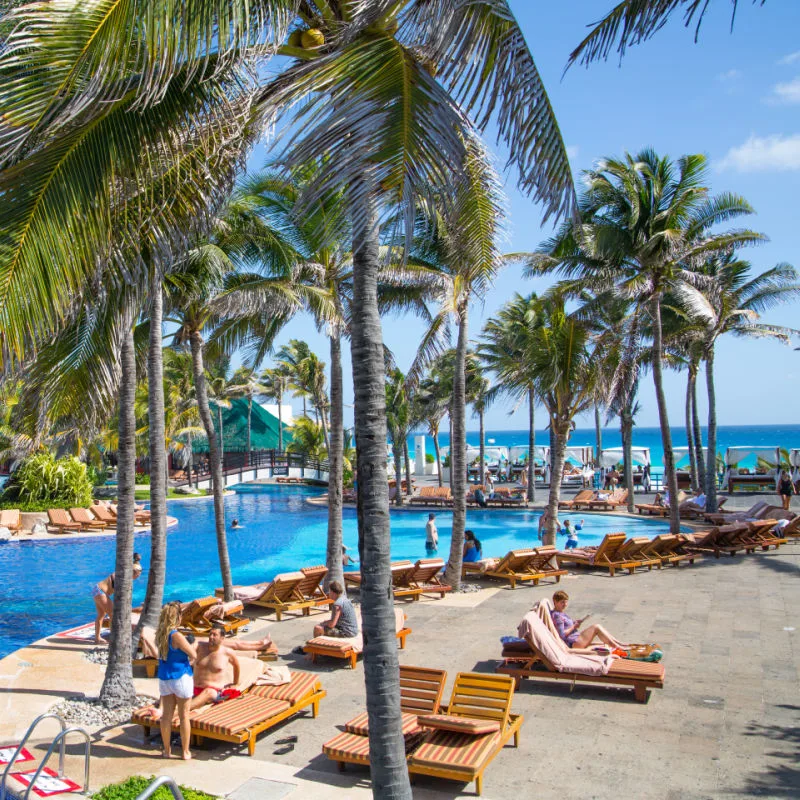 Beautiful Cancun Resort with Tourists Sitting Around the Pool