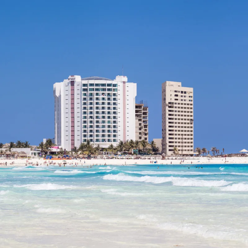 Tourists on the Beach and in the Water In Front of Hotel Krystal Cancun, Mexico