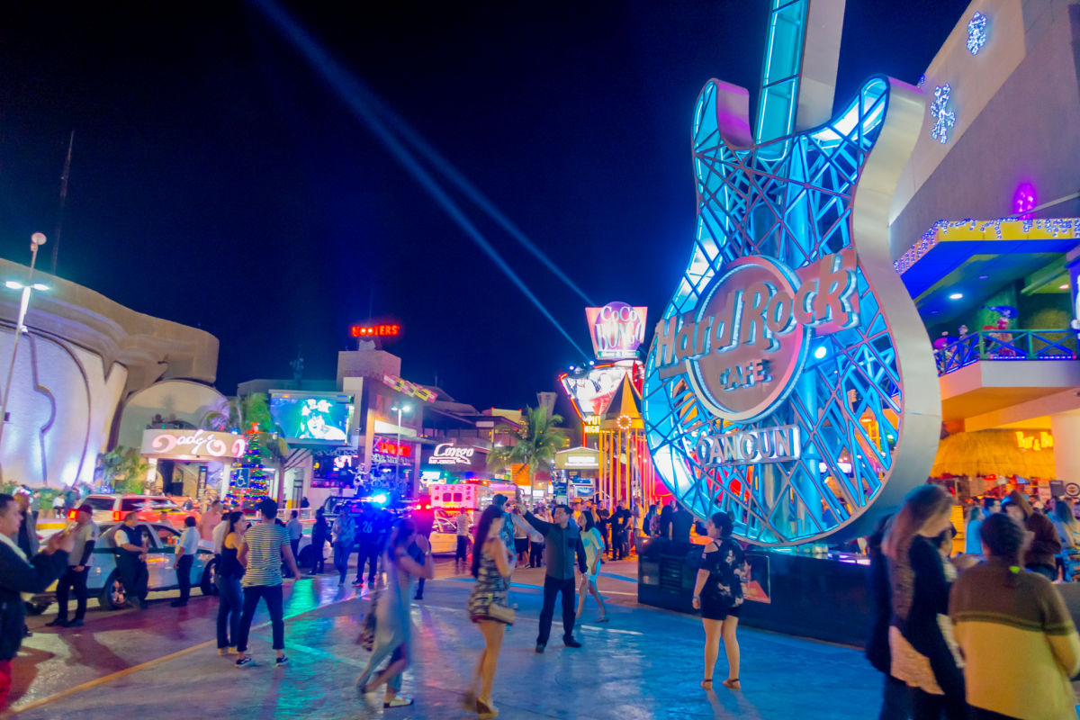 Tourists Walking Around in Front of the Hard Rock Cafe in the Hotel Zone in Cancun, Mexico