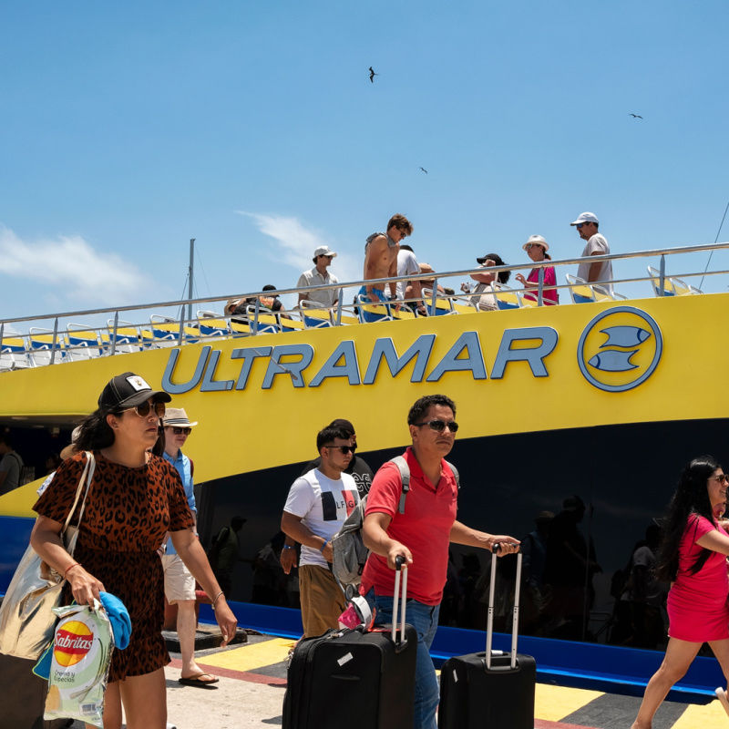 Passengers departing from an ultramar ferry in cancun 