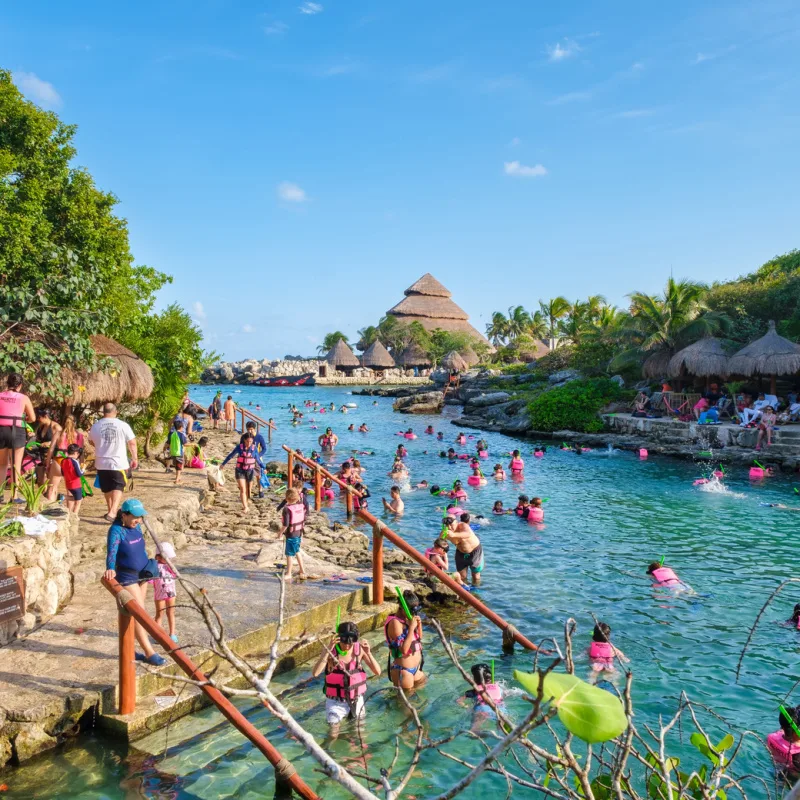 A Pool in Xcaret Park With Tourists Enjoying the Water