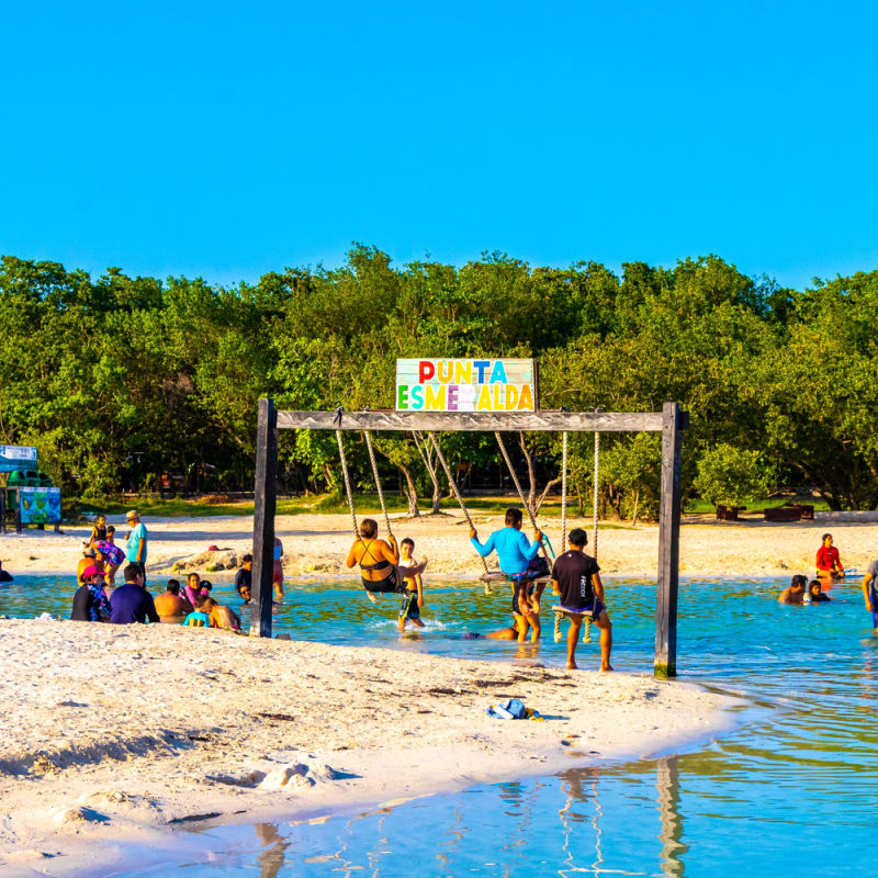 Punta Esmeralda beach cove with tourists on swings