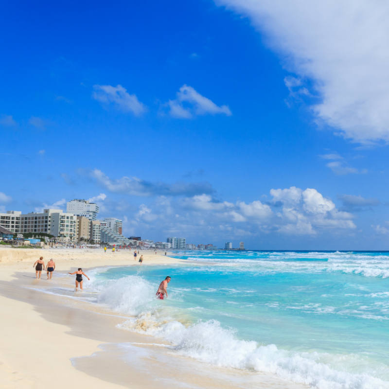 Cancun beach with people in ocean