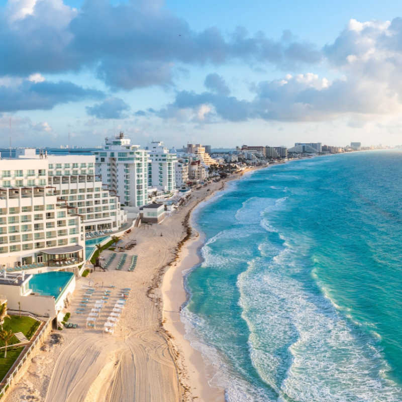 Cancun resorts and a white sand beach with blue water