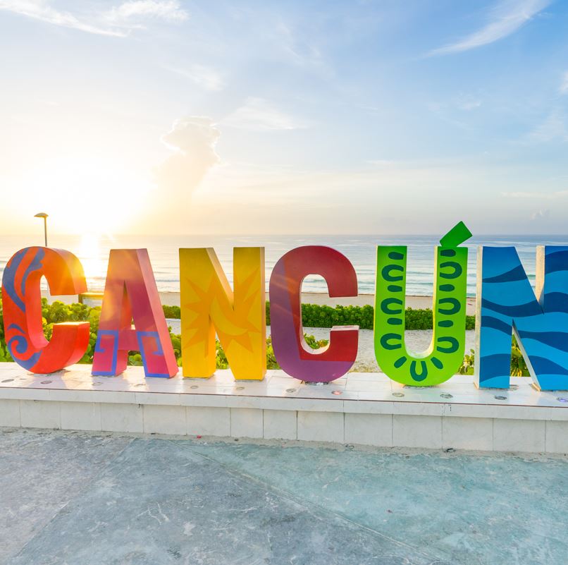 Colorful Cancun sign with ocean in the background