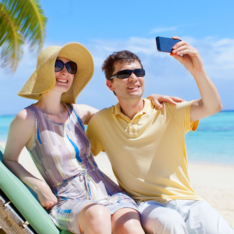 Couple on beach taking selfie