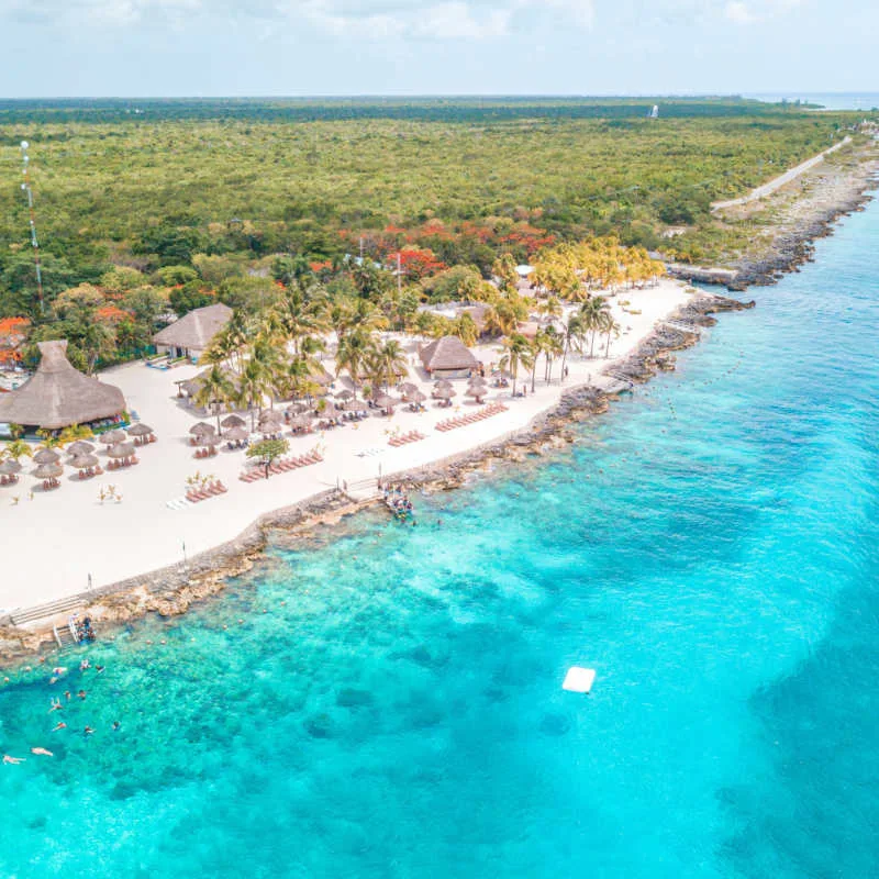Aerial view of a white sand beach in Cozumel with blue water