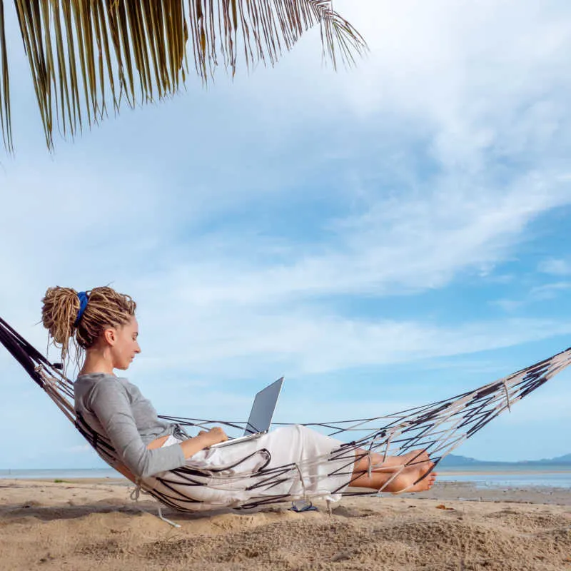 Digital nomad on a beach in the Caribbean