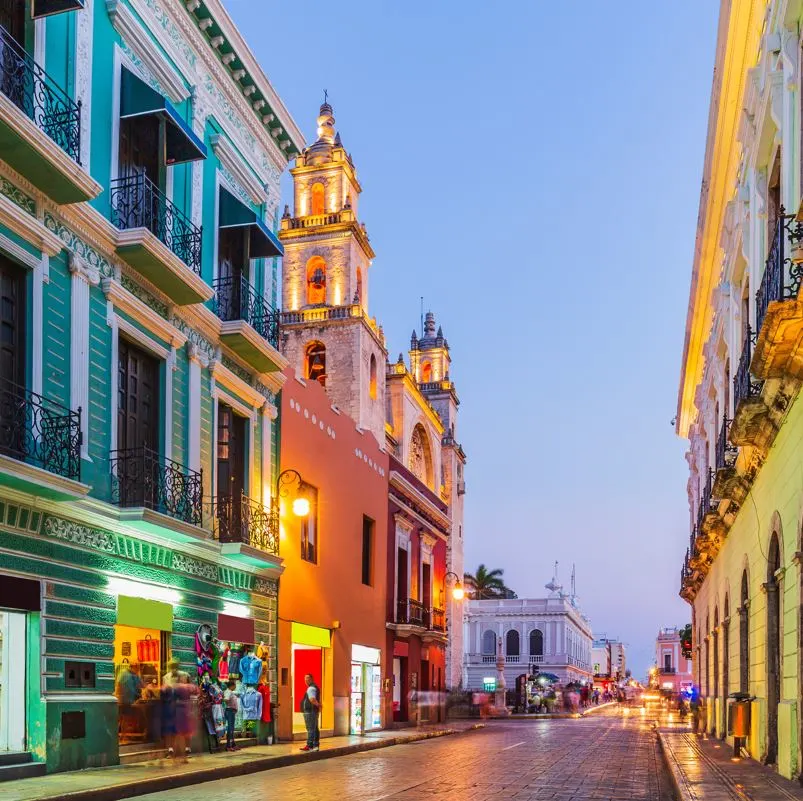 A colorful street at dusk in Merida