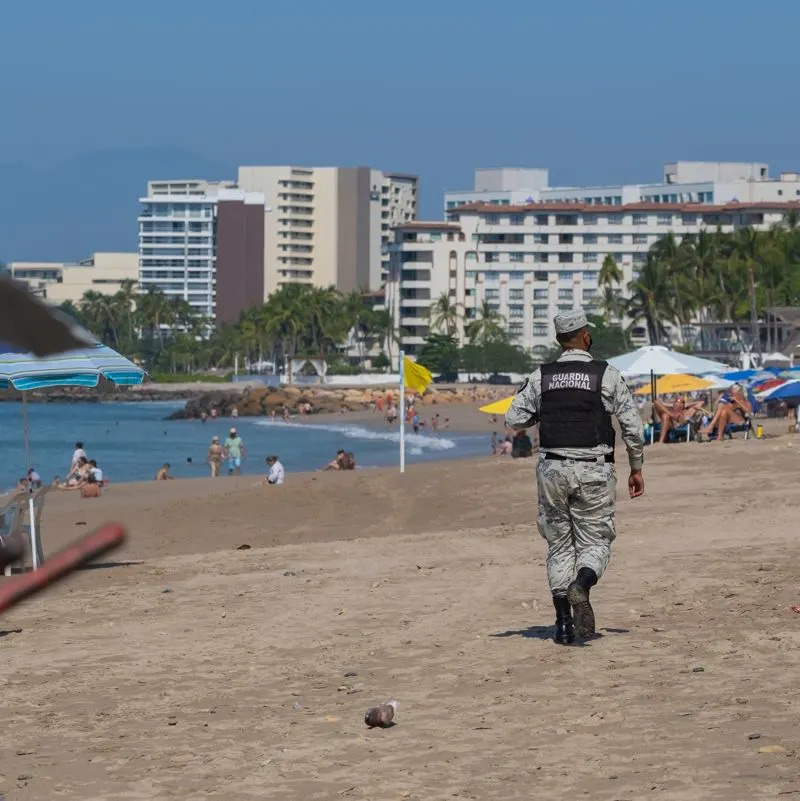 A Mexican national guard officer patroling a beach in Cancun
