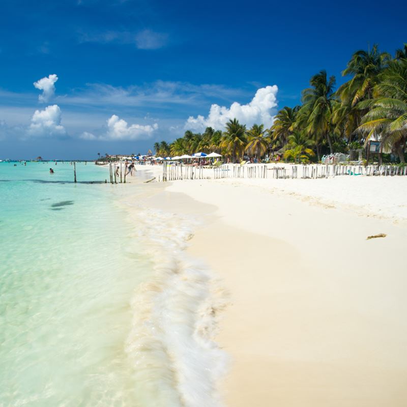Isla Mujeres Beach with beautiful white sand and blue skies