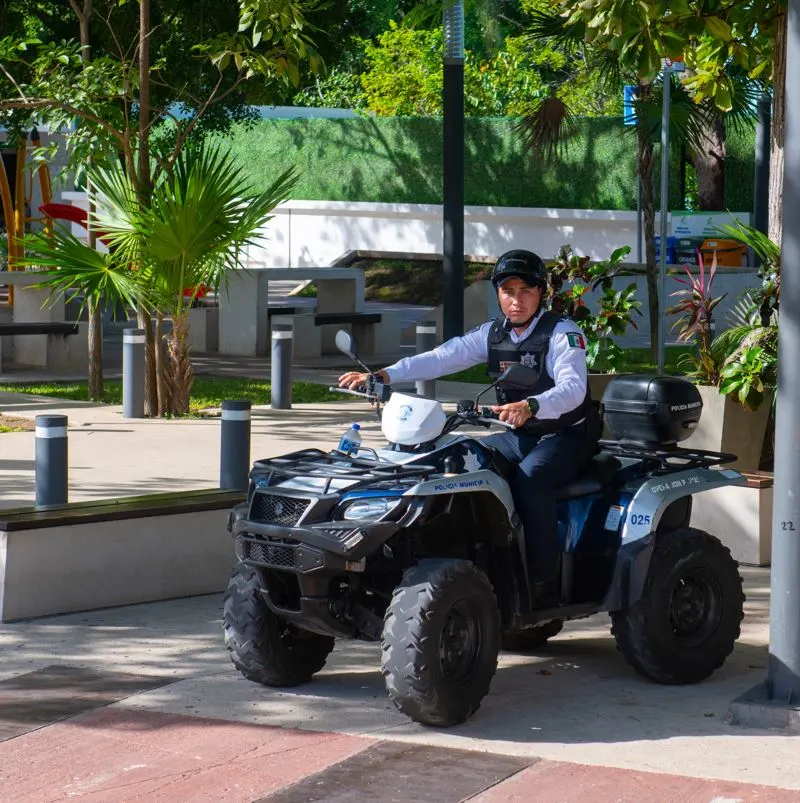 a police officer in playa del camrne on an atv