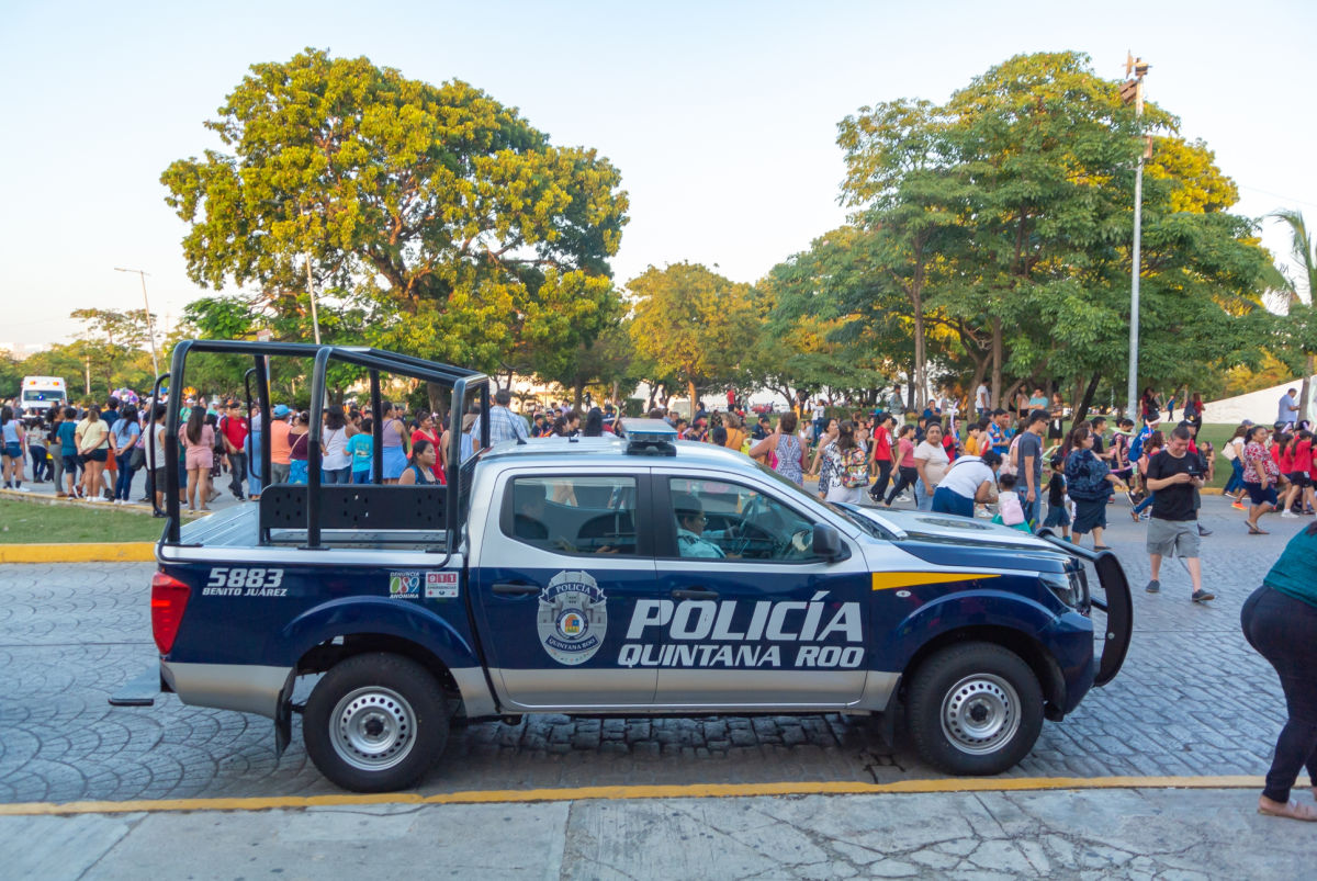 Police Vehicle Near a Crowd of People on a Street in Cancun, Mexico