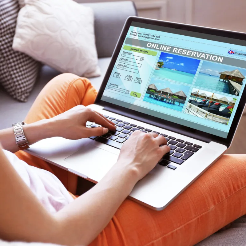 Woman Booking a Vacation to a Tropical Paradise Online