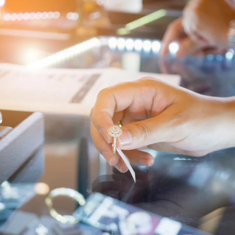 Woman Holding a Ring at a Jewelry Store