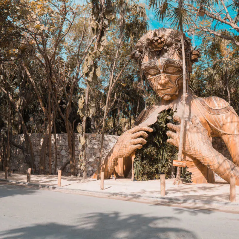 art sculpture entrance in Tulum of a person opening their heart as the doorway