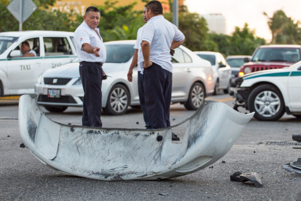 Two Cancun Taxi Drivers Talking to Each Other After a Car Accident