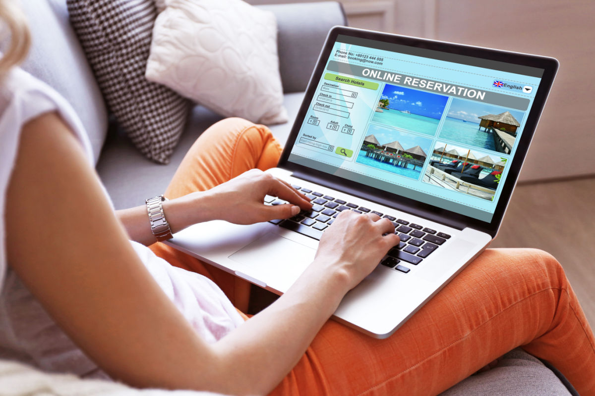 Woman Booking a Vacation to a Tropical Paradise Online