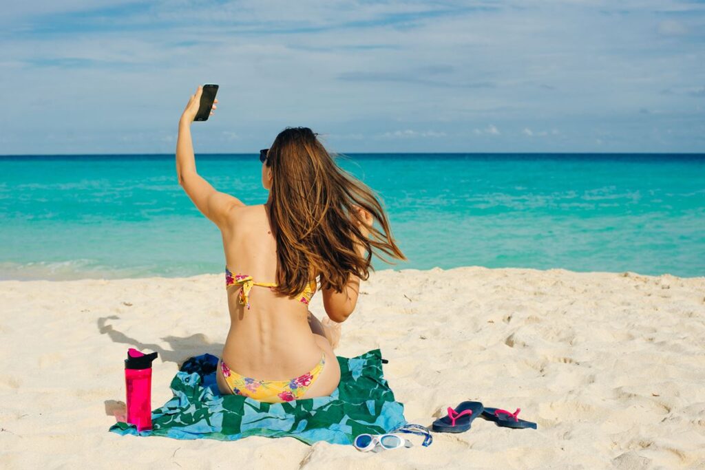 Woman on cancun beach with phone