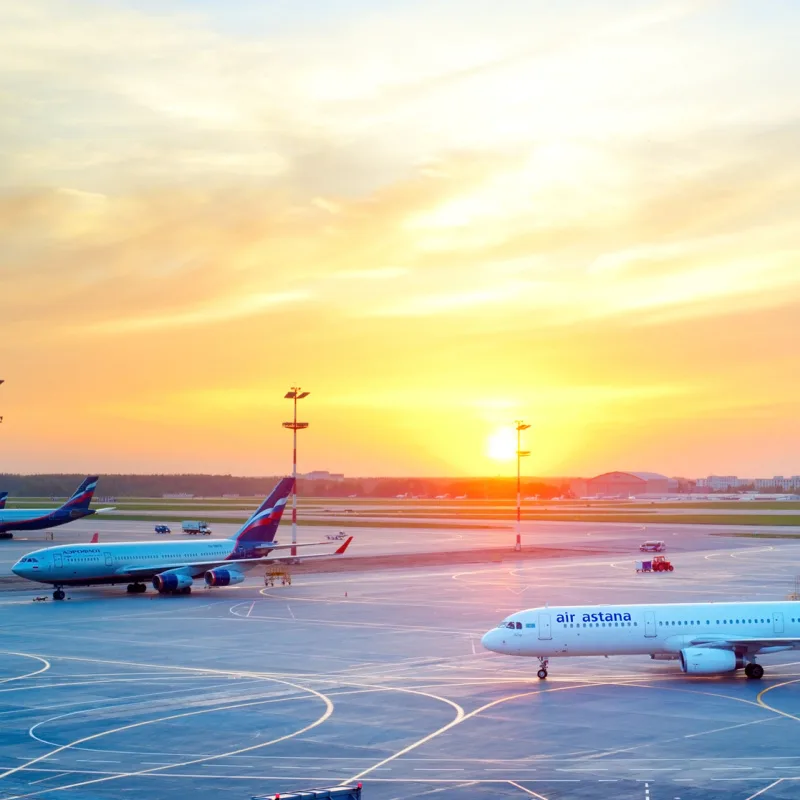 airplanes at sunset on tarmac