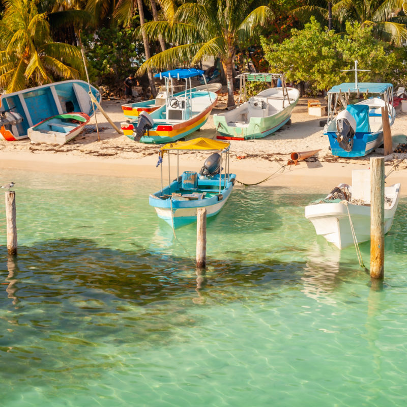 fishing boats docked on a beach in Isla Mujeres