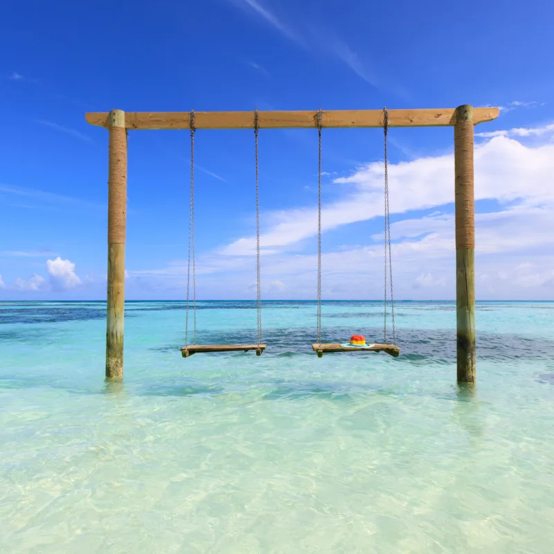 iconic swing in bacalar with crystal clear waters