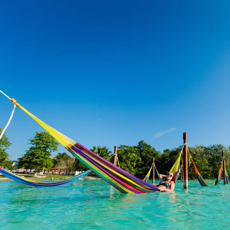 tourists enjoying sunbathing in a hammock in nthe mexican caribbean