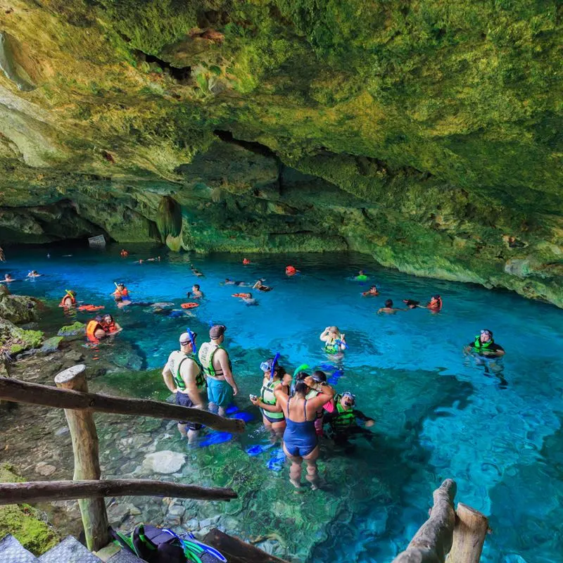 Tourists Swimming in a Cenote in the Mexican Caribbean