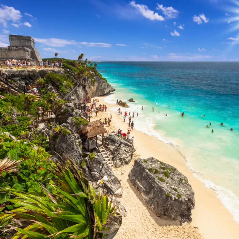 Tourists enjoying the ruins near a beach in Tulum