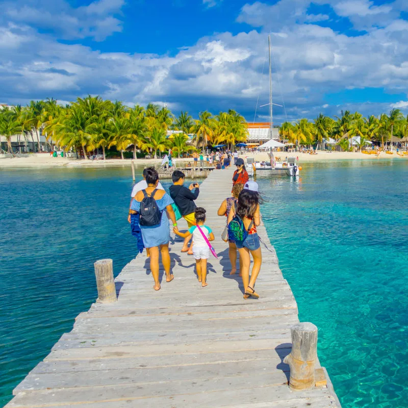 tourists arriving at boardwalk on playa del carmen

