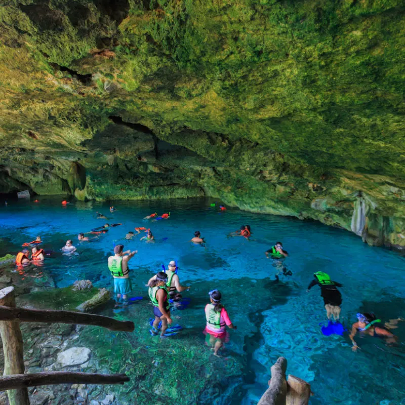 tourists in popular cenote in Tulum