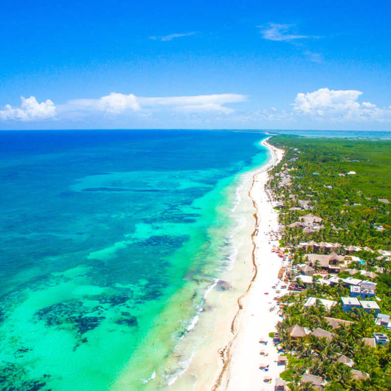 aerial view of a white sand beach in tulum 