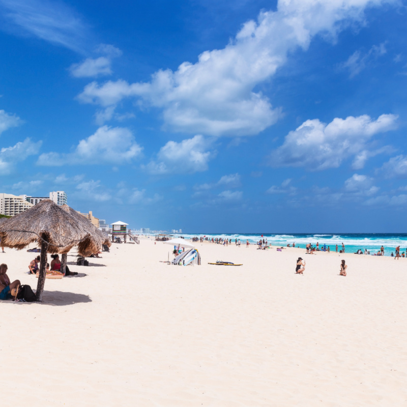 CANCUN, MEXICO - APRIL 8, 2020 Tourists on Dolphin beach in Cancun, Yucatan peninsula