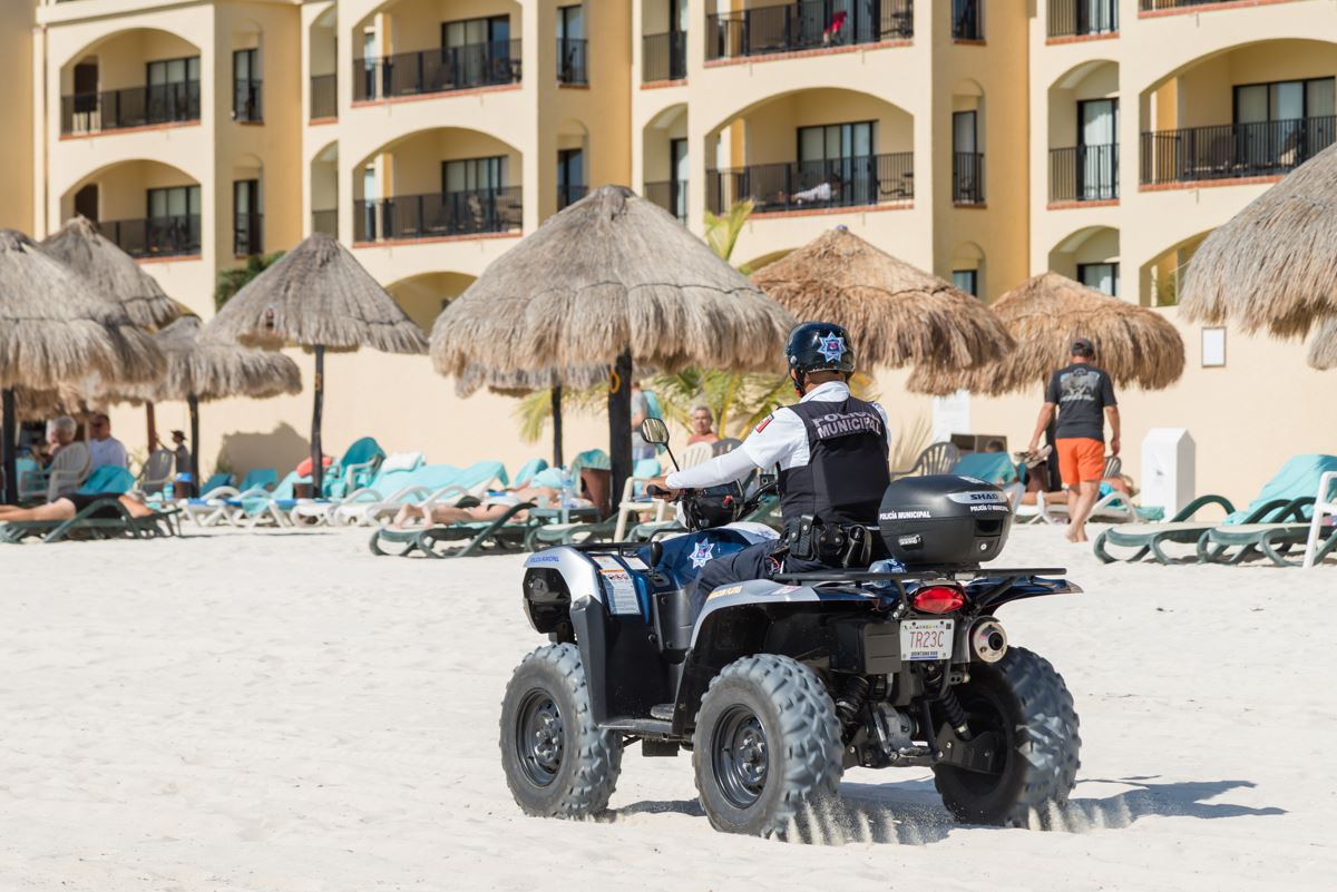 Cancun police officer on an atv on the beach