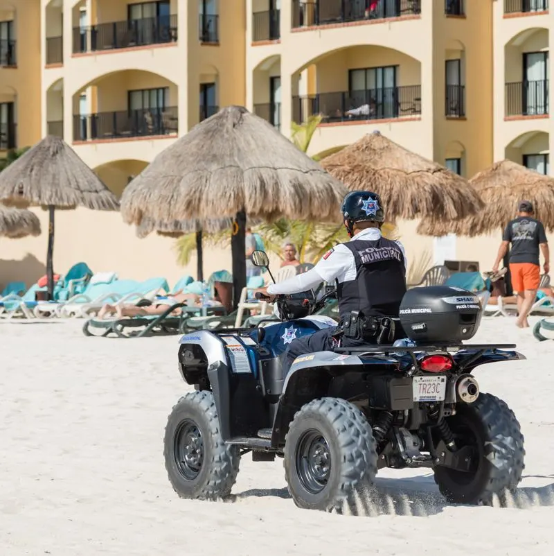 security patrols on popular beach, with police driving vehicle 