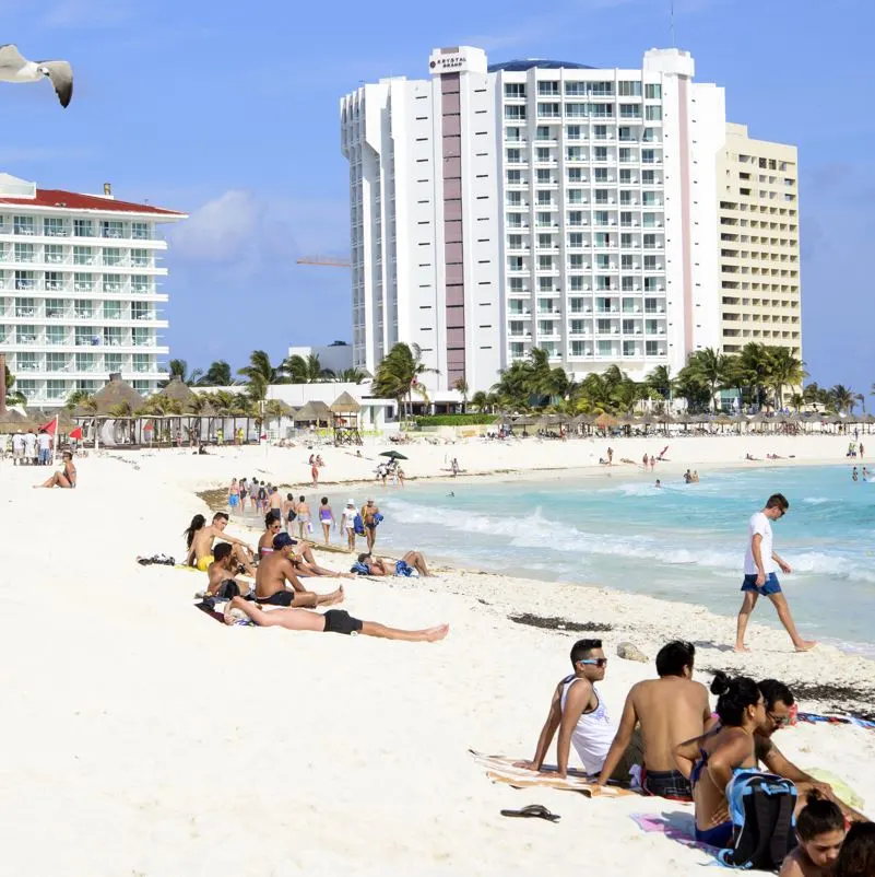 Tourists enjoying a beach in Cancun